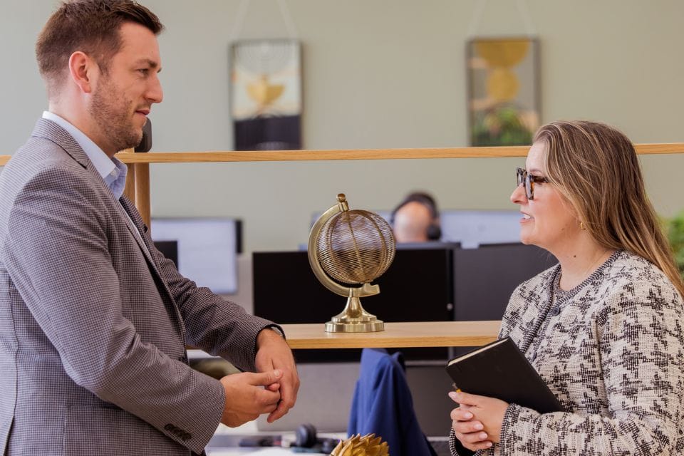 Daniel Porteous and Michelle Duncalf talking in the Weatherbys Private Bank office in Sunlight House, Spinningfields