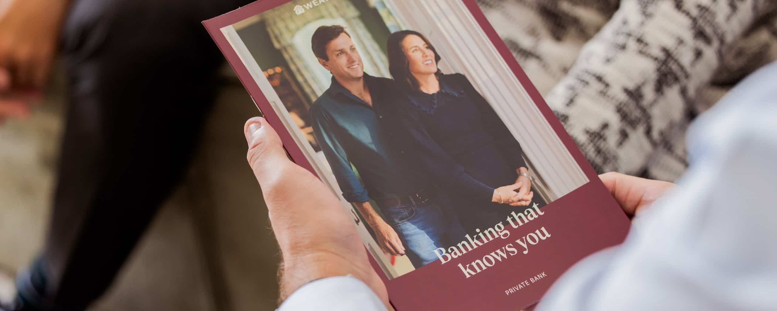 Person holding a Weatherbys Private Bank brochure