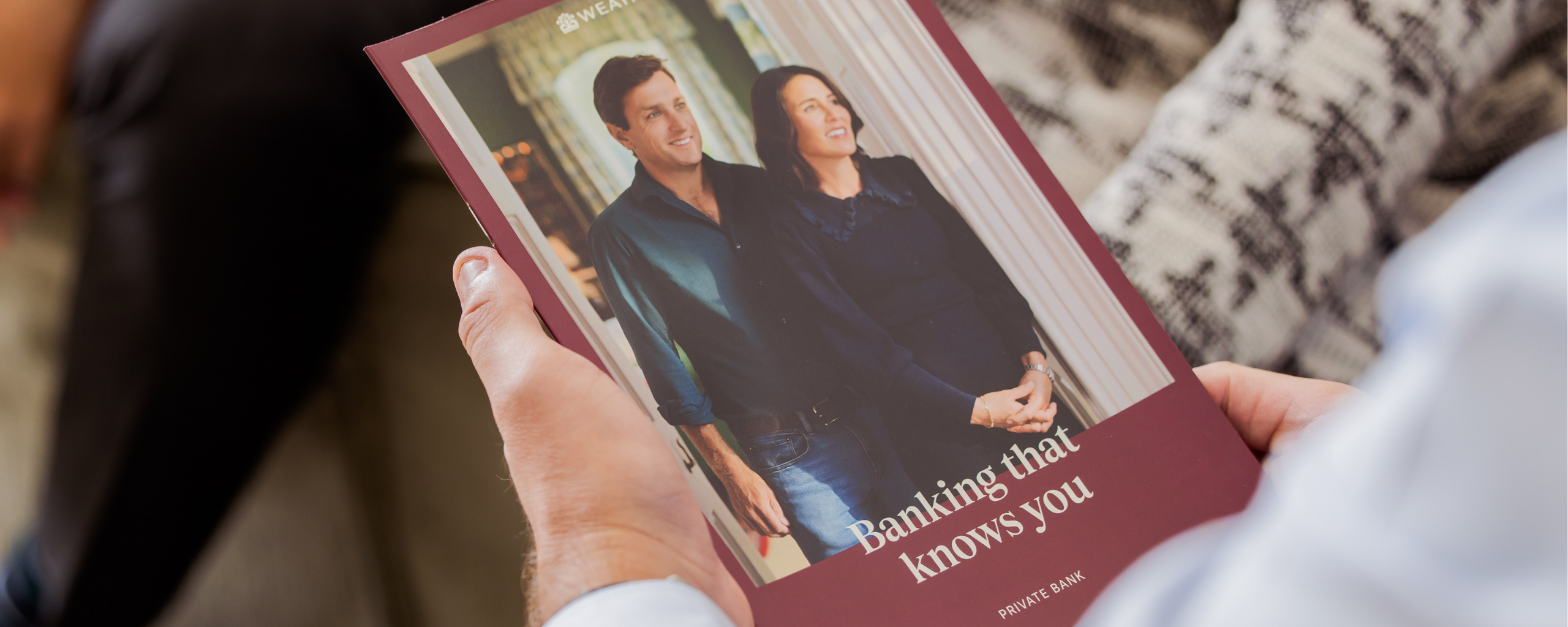 Person holding a Weatherbys Private Bank brochure